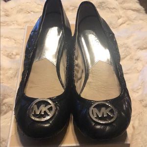 Michael Kors black ballet shoes with silver logo .